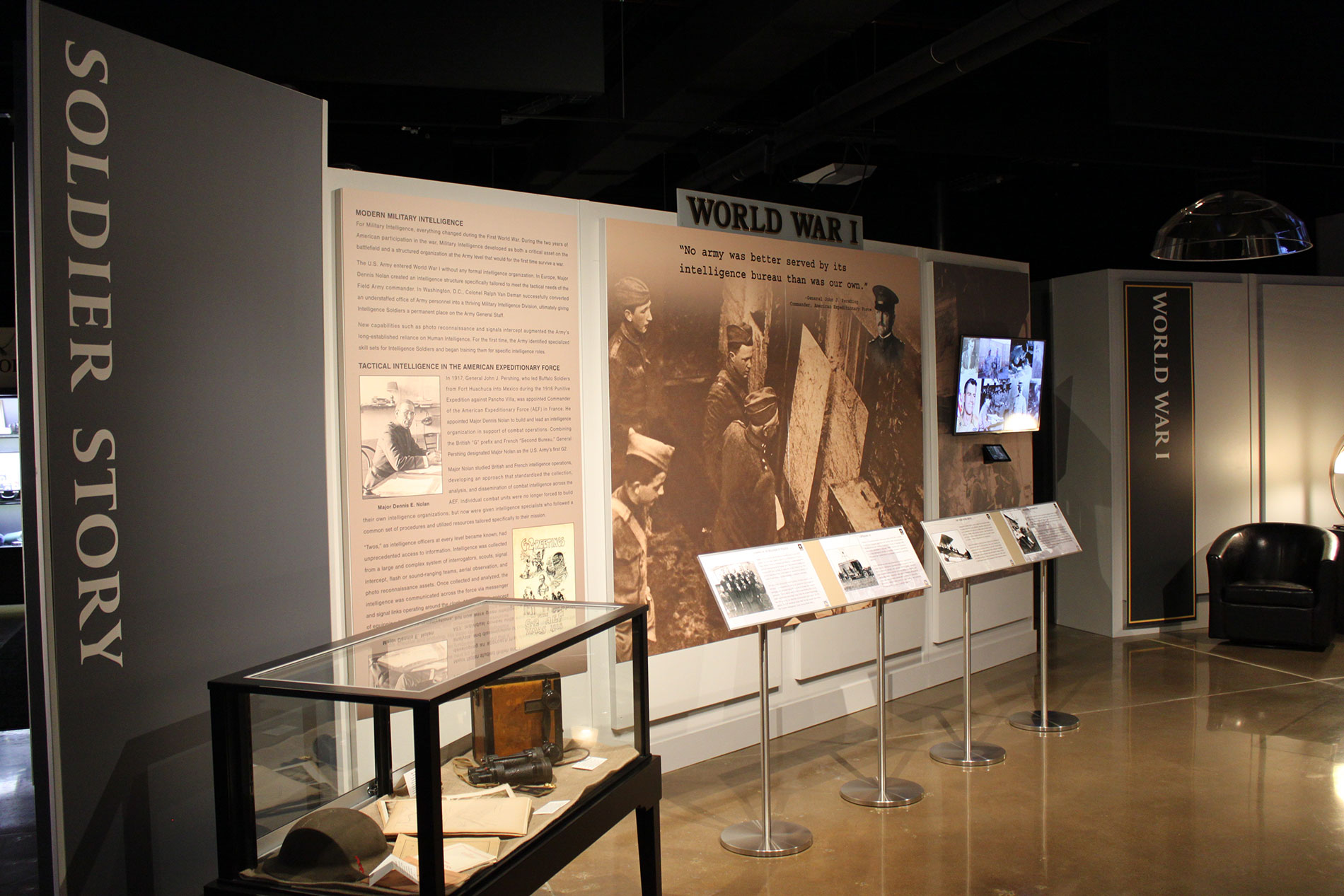 World War I exhibit with artifacts in glass enclosure and wall display.